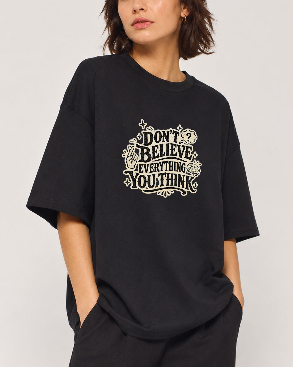 Don't Believe Everything You Think Pop Culture Graphic T-Shirt in Black, front model view 1