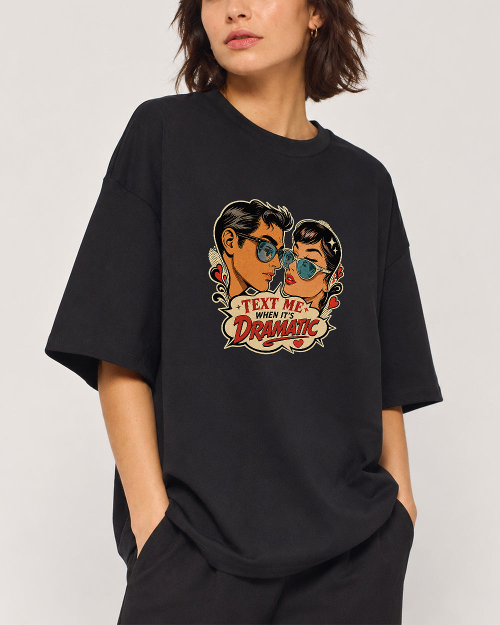 Text Me When It's Dramatic Funny Graphic T-Shirt in Black, front model view 1