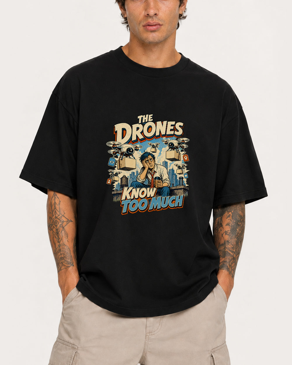 The Drones Know Too Much Funny Graphic T-Shirt in Black, front model view 1