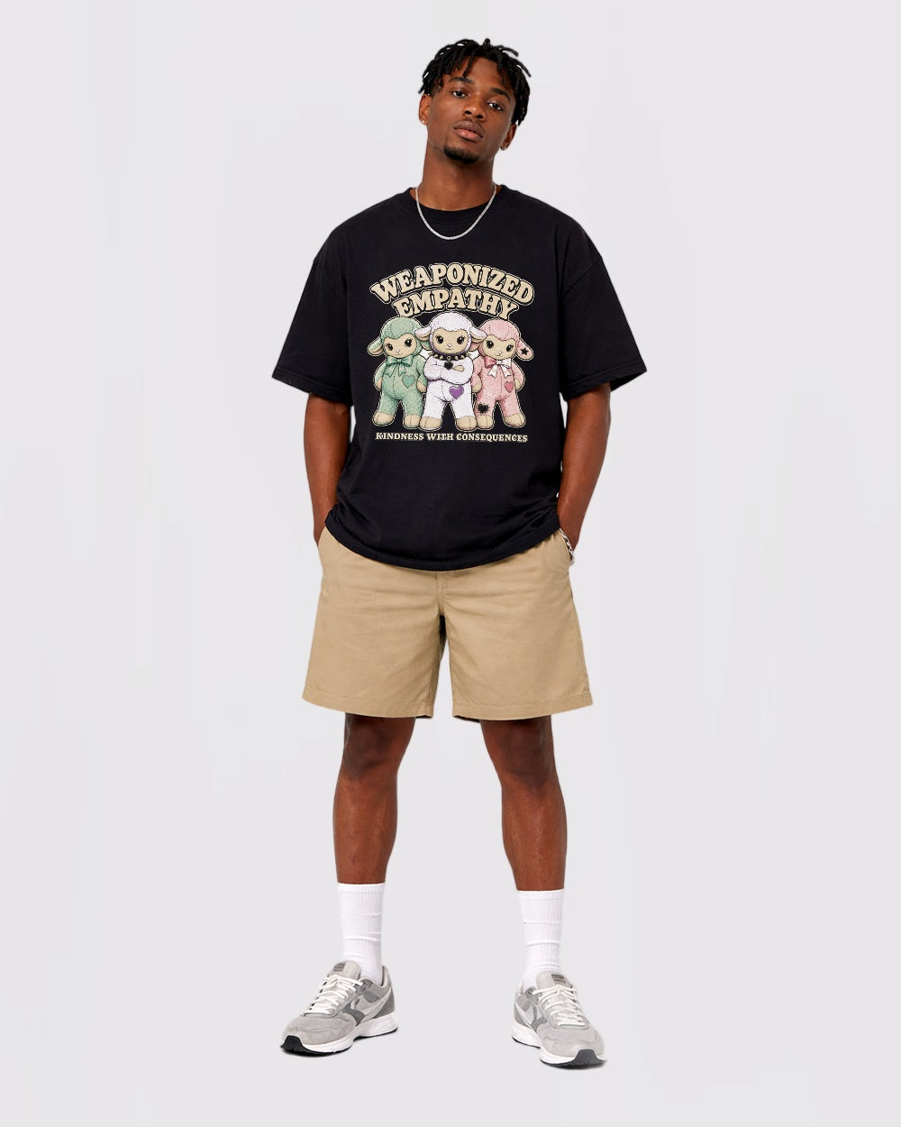 Model wearing the black Weaponized Empathy sheep T-shirt in a full-body front view